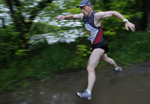 Kevin Noth of Bloomington navigated muddy spots during the Endless Summer Trail Run at Lebanon Hills Regional Park in Eagan.