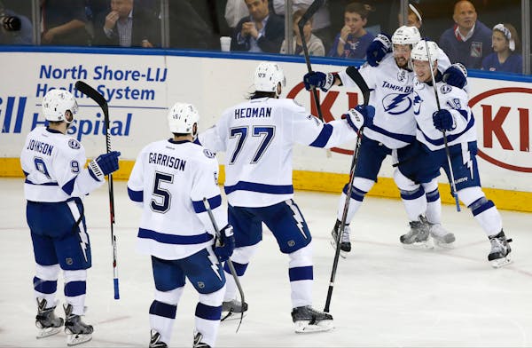 Tampa Bay Lightning left wing Ondrej Palat (18) and right wing Nikita Kucherov (86) celebrate with teammates after Palat's third period goal against t
