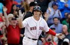 Boston Red Sox's Brock Holt claps after hitting a triple in the eighth inning of a baseball game against the Atlanta Braves at Fenway Park Tuesday, Ju