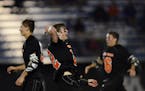 White Bear Lake's Joey Goudreau cheered and threw his equipment as teammates joined the celebration after his team upset Bloomington Jefferson 12-8 to