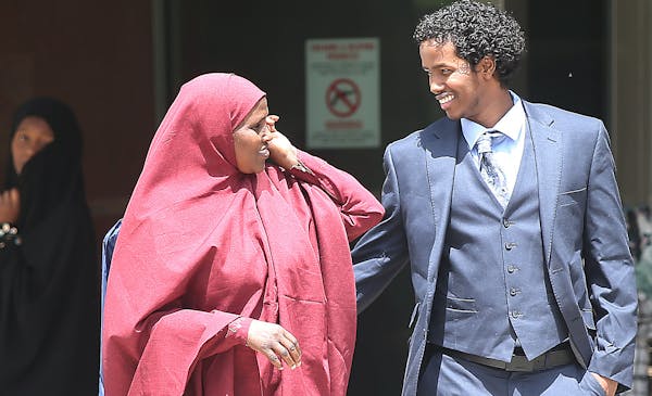 After seven months in detention, Mohamed Ali Omar, right, was greeted by family members outside the federal courthouse Tuesday.