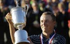 Jordan Spieth holds up the trophy after winning the U.S. Open golf tournament at Chambers Bay on Sunday, June 21, 2015 in University Place, Wash. (AP 