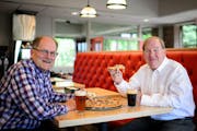 Bob Stupka, left, Davanni’s president and CFO, and Mick Stenson, founder and CEO, each had a beer with their pizza at Davanni’s in Edina, a restau