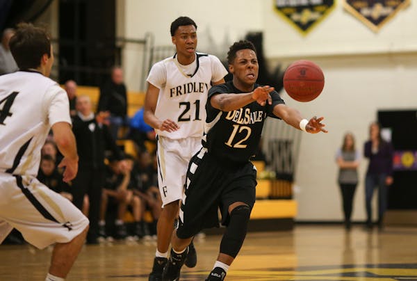 Jarvis Johnson (12) passed to a teammate in the first half of DeLaSalle's game against Fridley last season.