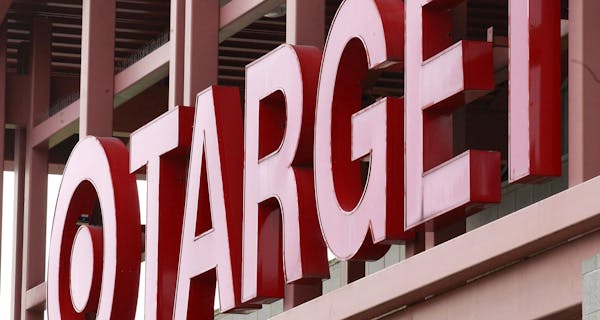 A Target sign is shown on the front of a Target Store.