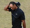 Tiger Woods walks off the 10th green during the first round of the U.S. Open golf tournament at Chambers Bay on Thursday, June 18, 2015 in University 