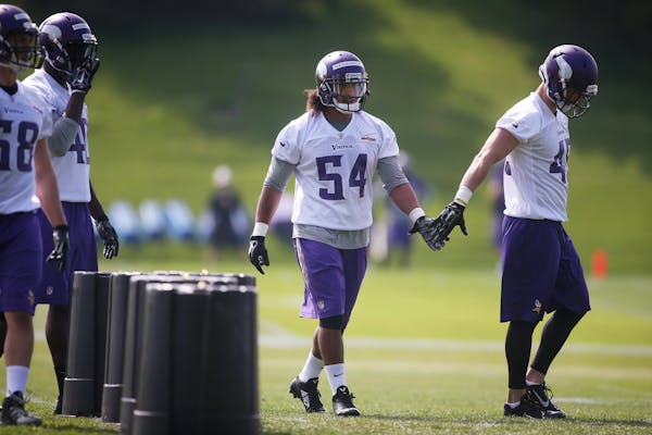 Rookies Eric Kendricks, center, and Brian Peters, right, slap hands during Vikings 2015 rookie minicamp.