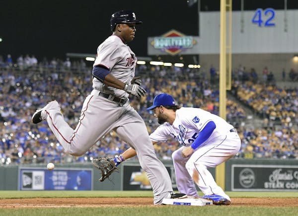 The Minnesota Twins' Miguel Sano beats out the throw to Kansas City Royals first baseman Eric Hosmer, right, for his first major league hit on a slow 