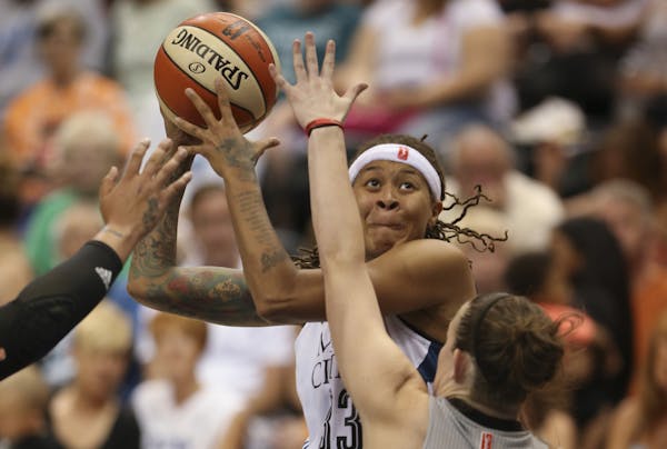 The Lynx' Seimone Augustus looked for a shot over San Antonio's Samantha Logic in the third quarter Sunday.