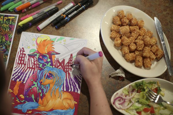 Bonnie Edwigenburg colored one of her own designs during the Thursday evening meeting of the Birdtown Coloring Club. An accomplished artist, it was he
