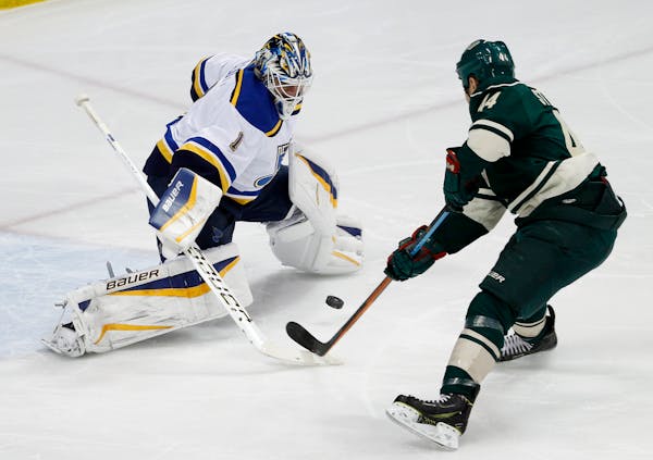 Minnesota Wild right wing Chris Stewart (44) shoots the puck under St. Louis Blues goalie Brian Elliott (1) to score during the first period of an NHL