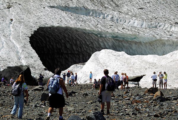 In this July 2010 photo, visitors examine the Big Four Ice Caves in the Mt. Baker-Snoqualmie National Forest near Granite Falls, Wash. The Snohomish C