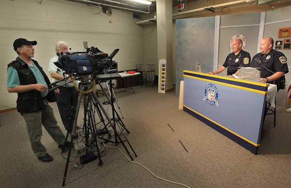 Mark Moore, cable coordinator, left, and Terry Devine, Center, taped a police show with Farmington Police officer Steve Kuyper, left, and Rosemount Po