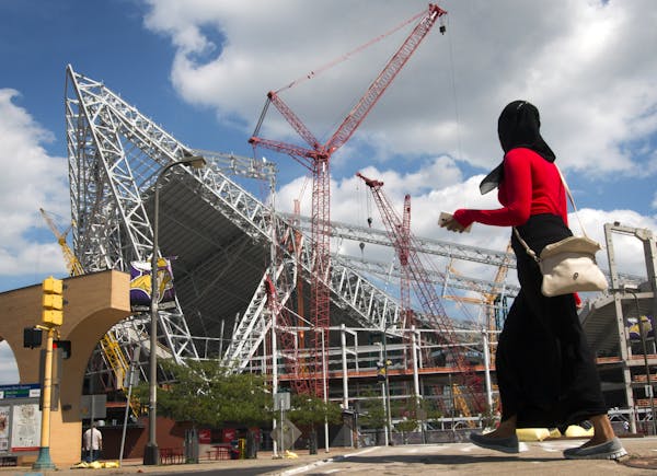 The new Vikings stadium is millions over budget, leading to some tense, closed-door meetings.