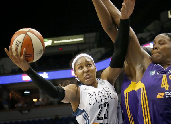 Maya Moore (23) drove for a shot while being defended against by the Sparks’ Jantel Lavender during an 82-76 Lynx win. Moore struggled with her shoo