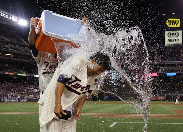 Twins catcher Kurt Suzuki was doused with water after his walk-off single made his team a 3-2 winner over Seattle on Saturday night at Target Field.