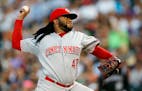 Cincinnati Reds starting pitcher Johnny Cueto worked against the Colorado Rockies in the seventh inning of a baseball game Saturday in Denver. The Kan