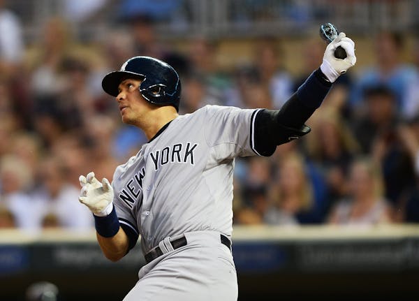 Alex Rodriguez followed through with his swing after hitting his third home run of the night in the top of the ninth against the Twins on Saturday nig