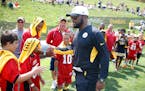 Pittsburgh Steelers coach Mike Tomlin greeted some of the youth football players attending the first session of practice at NFL football training camp