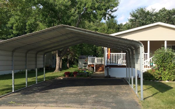 A carport the size of a two-car garage sits outside Kathryn Eich’s home in the Rambush Estates mobile home park in Burnsville. The city says it viol