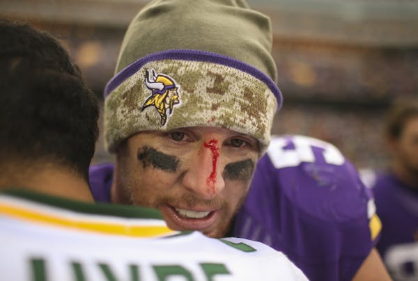 A bloodied Vikings outside linebacker Chad Greenway had a hug for Green Bay free safety Micah Hyde after the Nov. 23, 2014, game at TCF Bank Stadium.