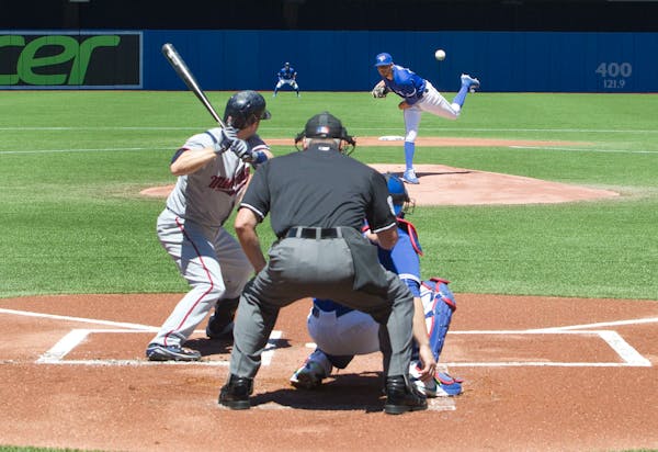 Toronto Blue Jays starting pitcher David Price throws against Minnesota Twins' Brian Dozier during the first inning of a baseball game in Toronto on M