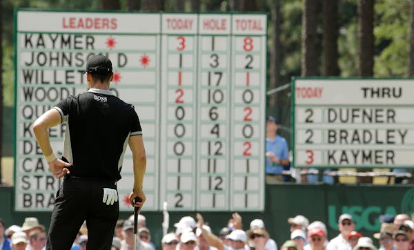 Martin Kaymer, of Germany, looks at his name on top of the leaderboard on the second hole during the second round of the U.S. Open golf tournament in 