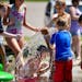 Kids played in the new splash pad at Cliff Fen Park in Burnsville Tuesday. Water from the park is not reused but drains into the nearby fen.