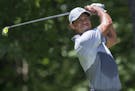 Tiger Woods tees off on the second hole during the third round of the Wyndham Championship golf tournament at Sedgefield Country Club in Greensboro, N