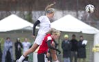 Lakeville North's Temi Carda leaps over the back of Eden Prarie's April Bockin to make a header during the second half of the Class 2A girls' soccer s
