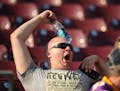 A fan cooled as he watched players warm up before the Vikings preseason game at TCF Bank Stadium Saturday night.