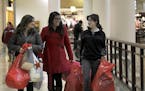Sisters from left, Yantzy Escoto, , Jimena Escoto, and Cynthia Escoto of West St. Paul, helped each other with their shopping bags at Rosedale Mall, e