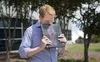 WDBJ news anchor Chris Hurst pauses as he is overcome with emotion while holding a photo album that was created by fellow reporter and girlfriend Alis