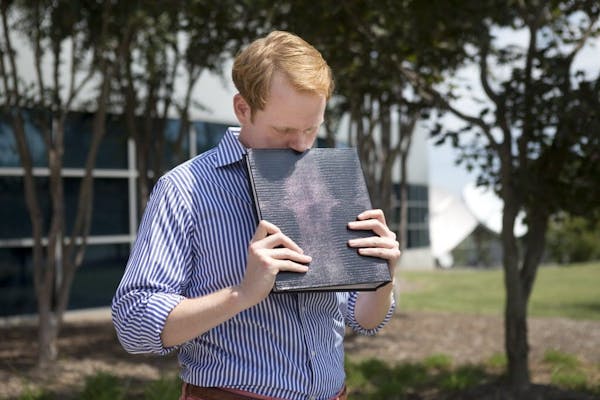 WDBJ news anchor Chris Hurst pauses as he is overcome with emotion while holding a photo album that was created by fellow reporter and girlfriend Alis