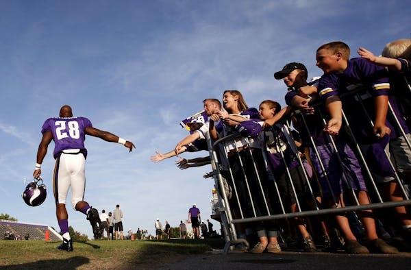 Minnesota Vikings running back Adrian Peterson (28) was greeted by fans before practice on Tuesday evening.