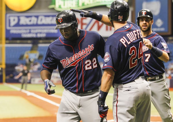 The Minnesota Twins' Trevor Plouffe (24) congratulates teammate Miguel Sano (22) on his three-run home run in the first inning against the Tampa Bay R