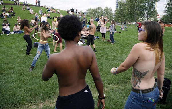 Saying it’s a matter of gender equity and freedom of expression, topless demonstrators danced at Gold Medal Park Sunday August 23, 2015 in Minneapol