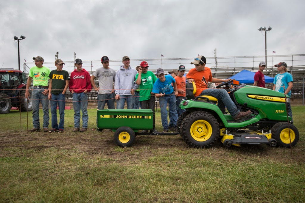 A group of boys in Benton, Minn., watched 13-year-old Brandon Pyka compete at a 4-H/FFA tractor driving contest, one of the few such competitions and training events still held. Tractor training is available to high school students in just two of the state's 87 counties. 
