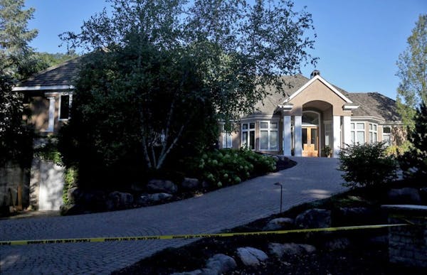 Yellow crime tape marked off the Greenwood home of the Brian and Karen Short family, where all five members of the family were discovered dead Thursda