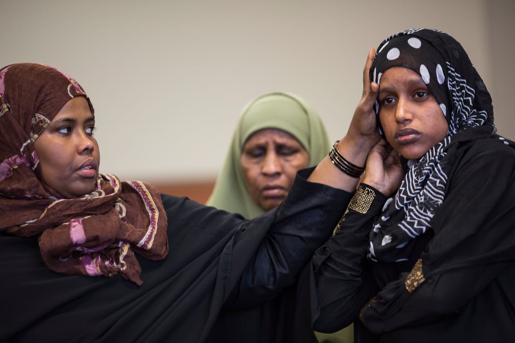 Ayan Farah, left, the mother of Adnan and Mohamed Farah, reached out to comfort Hodan Moar, sister of Guled Omar, during a meeting in St. Paul in May. Farah's two sons and Moar's brother had been arrested the previous month and charged with conspiring to go to Syria to aid Islamic State militants.