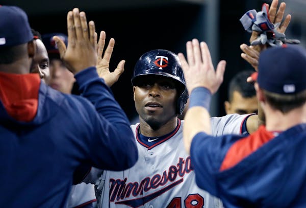 Minnesota Twins' Torii Hunter is congratulated after scoring during the seventh inning of a baseball game against the Detroit Tigers, Saturday, Sept. 