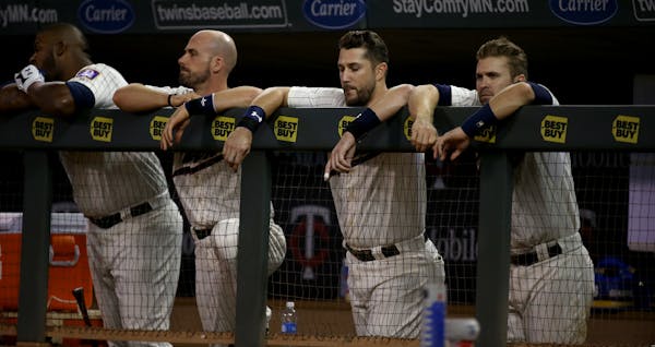 Twins players watched the second game of a doubleheader at Target Field come to a close Saturday night. The Twins were swept by the Los Angeles Angels