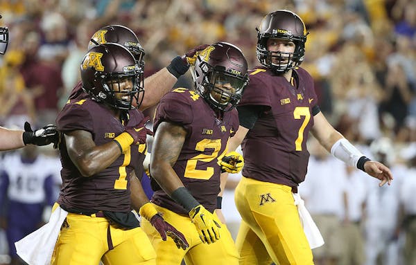 Minnesota's running back Rodney Smith was congratulated by his teammates after a touchdown during the third quarter as the Gophers took on TCU at TCF 