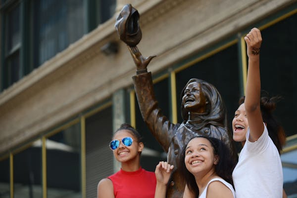 From left, Shanell Carter, Alana Ingram-Diego and Alayna Ap, all of St. Paul, posed for their friend’s camera phone on the Mary Tyler Moore statue o