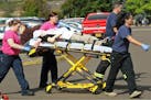 Authorities carry a shooting victim away from the scene after a gunman opened fire at Umpqua Community College in Roseburg, Ore., Thursday, Oct. 1, 20