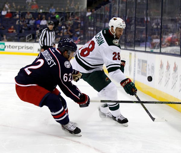 Minnesota Wild's Tyson Strachan, right, works for the puck against Columbus Blue Jackets' Alex Broadhurst during an NHL preseason hockey game in Colum