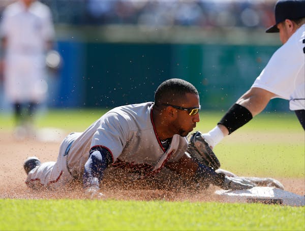 Minnesota Twins' Eduardo Nunez beats the tag of Detroit Tigers' 'Nick Castellanos as he steals third base during the fifth inning on Sunday, Sept. 27,