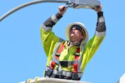 Lyon-Lincoln Electric Coop Lineman Dan Tutt installs an LED Street Light in Russell, Minn., in 2014. More cities are saving money and improving night 