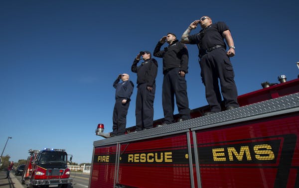 Brooklyn Park firefighters, from left, Dave Schmidt, Brandon Hollingsworth, Taylor Anderson and Pat Roepke stood atop a fire truck on the Interstate 9