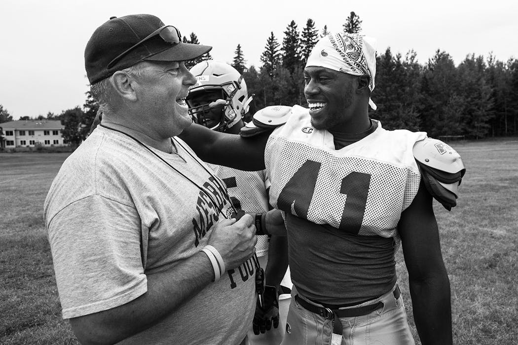 Mesabi Range College head coach Dan Lind shared a laugh with wide receiver Denzel Washington, from Live Oak, Florida, during a mid-August practice.